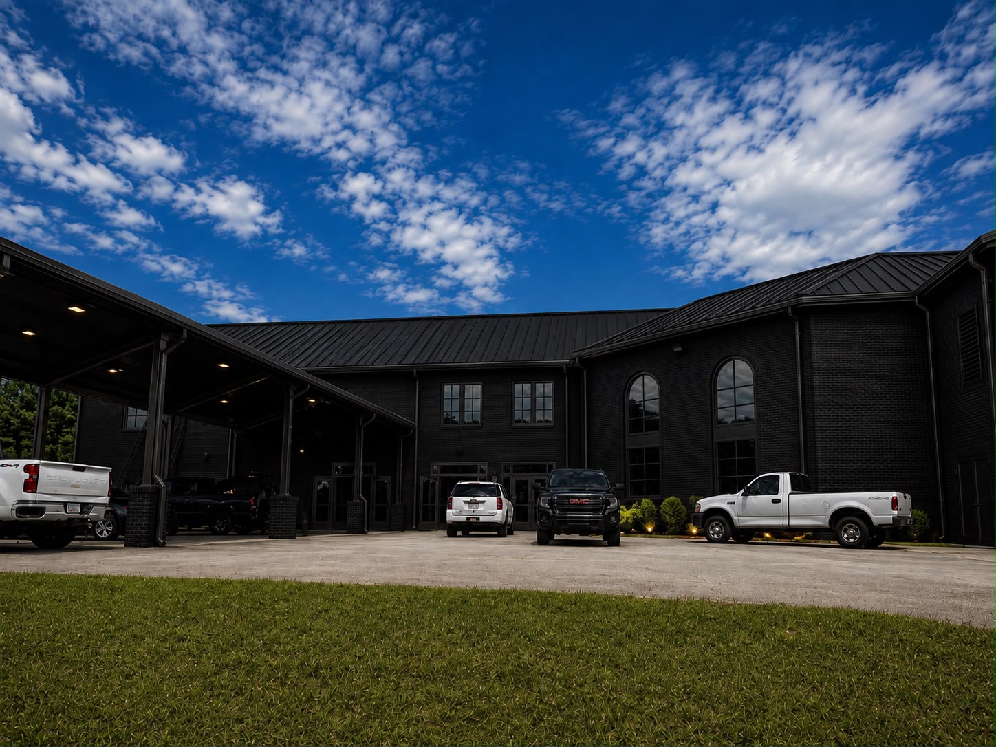 Black brick exterior of Invictus Event Center with covered arrival canopy